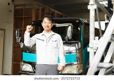 Construction image of a middle-aged man posing in front of a truck