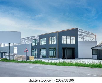 construction of an industrial building with a metal frame and sandwich panels