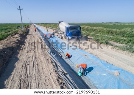 Construction of an irrigation canal. Earthworks, laying the foundation of the water channel.