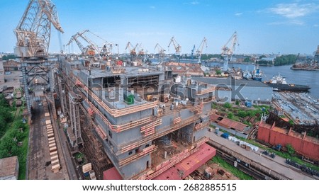 The construction of a large ship on a shipyard timelapse with cranes. A fragment of the case in the workshop of the plant. Metal frame during assembly from above
