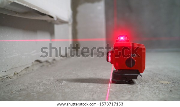 Construction laser level in a building\
under construction. Laser equipment at a construction\
site