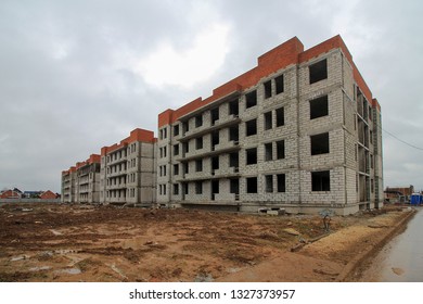 Construction low  rise monolithic brick block houses according to standard design  Empty construction site    project is not built    Unfinished construction  Four storey country house in suburbs 