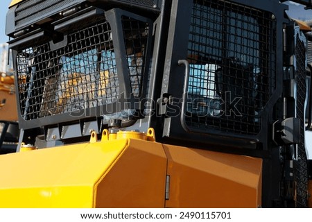 Construction machine cab with roll over ROPS and falling objects FOPS protective structures. Selective focus.