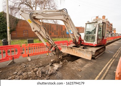 Construction Machine Digging A Trench In A Road