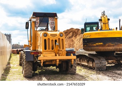 Construction machine Motor Grader at a construction site level for the ground and gravel stones for the construction of a new road. road construction equipment