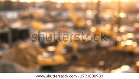 Construction machinery and vehicles operating within an industrial project area. Building and development work underway at the site.
