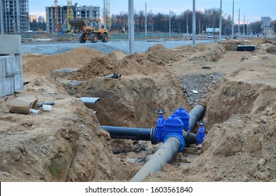 Construction of main water supply pipeline. Laying underground storm sewers at construction site, water main, sanitary sewer, drain systems. Installation of the gate valves for city groundwater system