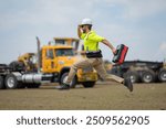 Construction man funny jump with helmet. Worker at construction new building. Builder at construction site. Foreman workman portrait. Builder in helmet outdoor portrait. American worker in hardhat.