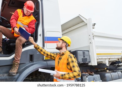 Construction Manager With Checklist And Truck Driver Discuss Delivery At The Construction Site