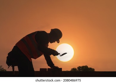 Construction mason worker bricklayer construction worker laying bricks and building barbecue in industrial site. - Shutterstock ID 2080486975