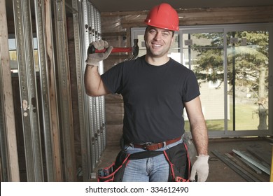 A Construction Men Working On A Bilding House.