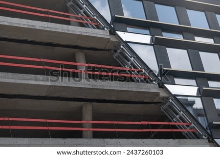 Construction of metal concrete structures in architecture, with safety railings on the construction site. real estate development, new architectural floors, columns in construction site. 