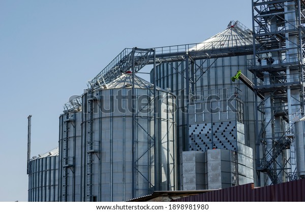 Construction of a metal grain storage. Cylinder\
silos for wheat, corn, barley and other grain crops. Industry,\
agribusiness. Without\
anyone