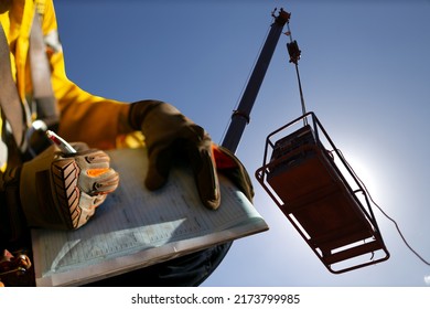Construction miner supervisor wearing  safety glove signing working at height working permit on open field job site prior to starting high risk crane lifting at construction mine site Australia - Shutterstock ID 2173799985