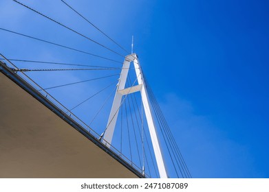construction of a modern cable-stayed bridge on background of blue sky in Anhor Park in Tashkent in Uzbekistan. New pedestrian suspension bridge