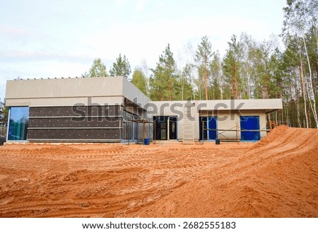 Construction of Modern House Surrounded Trees. Building modern Double Court house in forest. Suburb building development. Exclusive Custom Villa construction. One-story house Building. Luxury Villa.