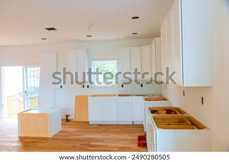 In construction of new house, custom kitchen cabinets are installed at kitchen montage