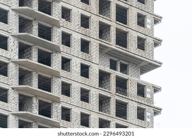 Construction of new modern building. Engineering multistory design from foam-concrete block and overlap. Development high-rise apartment with place for windows and balcony. Construction of new house.