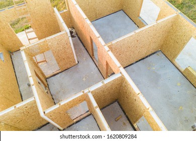 Construction Of New And Modern Modular House. Walls Made From Composite Wooden Sip Panels With Styrofoam Insulation Inside. Building New Frame Of Energy Efficient Home Concept.