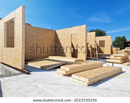 Construction of new and modern prefabricated modular house from composite wood panels. Energy efficient panel assembling