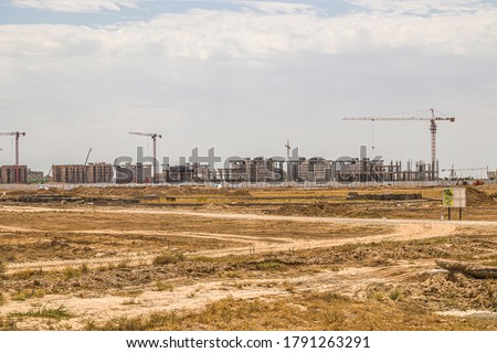 .Construction of new multi-storey modern houses in Turkestan in the steppe in Kazakhstan.