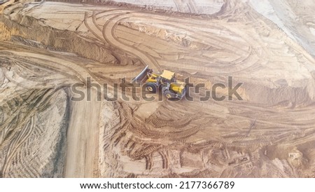construction of a new toll road, solar glare, selective focusing, construction equipment at the road construction site close-up, road infrastructure construction concept