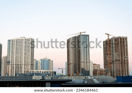 construction od building. industrial crane at construction site. architecture. constructing skyscraper. construction crane. cityscape.
