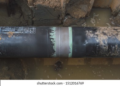 Construction of Oil and Gas Pipeline,Sandblasting  removing rusty from metal pipeline at connection joint  weld of pipe, Sandblast for Cleaning and Surface Preparation.Technology in the industry.