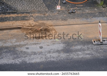 Construction paving work while fiber or fibre optic network expansion. Finished work during construction activities for the installation of fiber optic lines for home connections in a street
