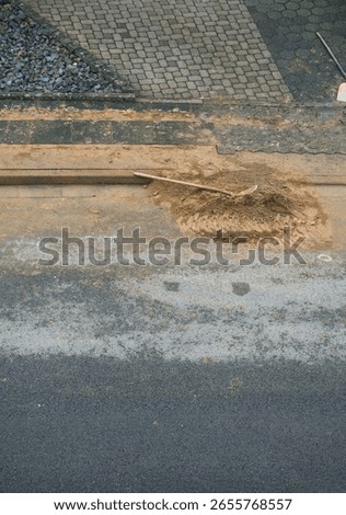 Construction paving work while fiber or fibre optic network expansion. Finished work during construction activities for the installation of fiber optic lines for home connections in a street