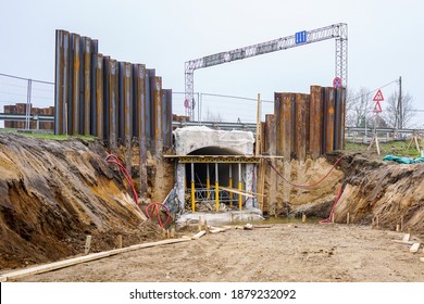 construction of a pedestrian tunnel under the highway, temporary metal retaining wall support the foundation