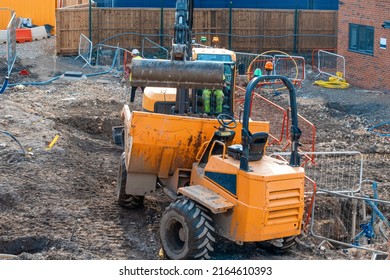 Construction plant and machinery. Dumper and excavator working on new homes construction site