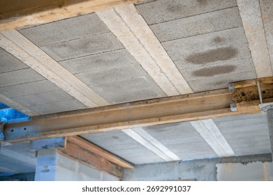 Construction process: installation of beam-and-block floor system on prestressed beams. Bottom view. Concept of strength, engineering precision, and technology.