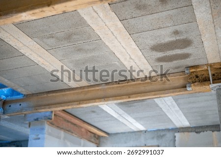 Construction process: installation of beam-and-block floor system on prestressed beams. Bottom view. Concept of strength, engineering precision, and technology.