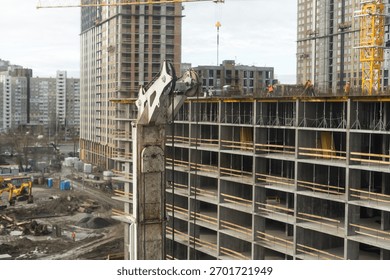 The construction process of a residential complex. Many high-rise cranes against the background of new buildings