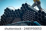 Construction products on transport vehicles Group of steel pipes for industrial materials Construction engineering products  equipment, steel pipes, metal warehouse industry, delivery to customers