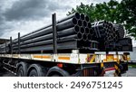 Construction products on transport vehicles Group of steel pipes for industrial materials Construction engineering products  equipment, steel pipes, metal warehouse industry, delivery to customers