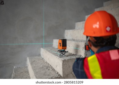 Construction professional utilizing a laser level to ensure precise measurements on staircases at a building site