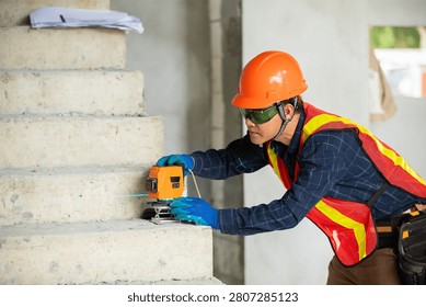 Construction professional utilizing a laser level on a staircase to ensure accurate measurements during a building project