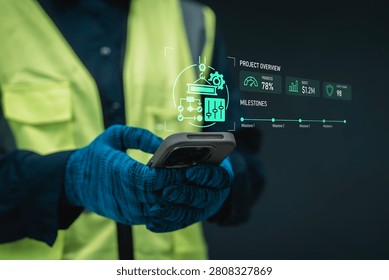 Construction project control concept worker holding smartphone digital hologram project overview crane flowchart milestone timeline and budget for industrial operational oversight and management