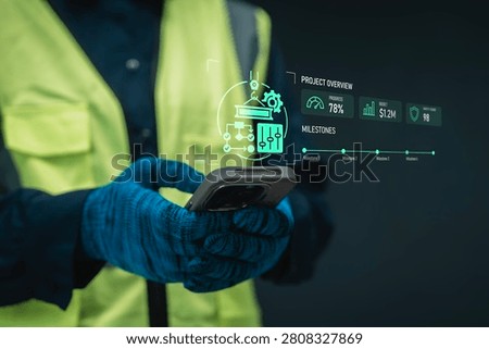 Construction project control concept worker holding smartphone digital hologram project overview crane flowchart milestone timeline and budget for industrial operational oversight and management