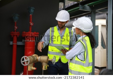 Construction project engineer check and discussing at front of fire Fighting valve or fire hydrants . new project for Fire Extinguishing system 