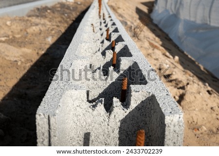 Construction project: Using concrete and iron blocks on a construction site to build a safe and robust wall