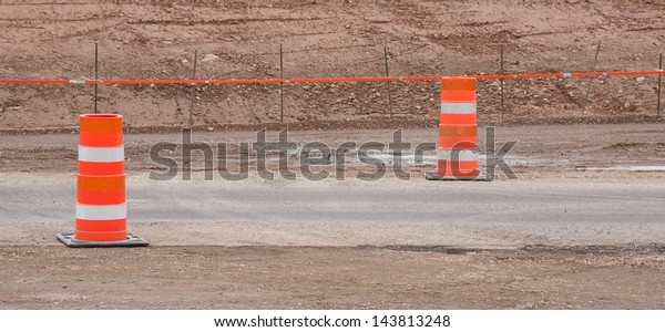 Construction pylons at an\
outdoor work site