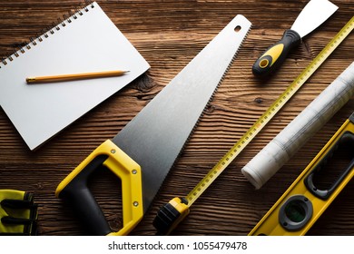 Construction And Renovation Concept. Contractor Tools, On Wooden Table. Top View Shot.