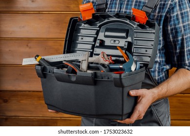 Construction and repair - a male worker or Builder with working tools in a box.