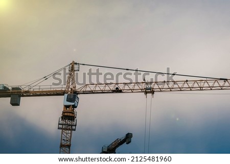 Construction of residential buildings, construction crane against the sky. Construction concept.
