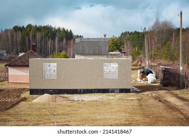 Construction Of Residential House In Countryside, Private House From White Gas Silicate Blocks, Unfinished Walls And Roof Under Construction. Building Of New Rural House. 