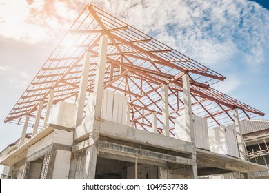 construction residential new house in progress at building site - Shutterstock ID 1049537738