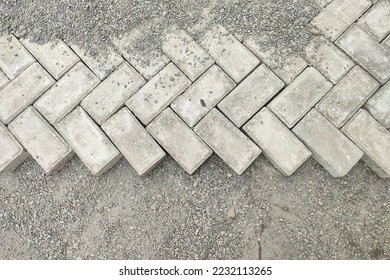 Construction of roads that are still unfinished, half paving blocks, half sand
